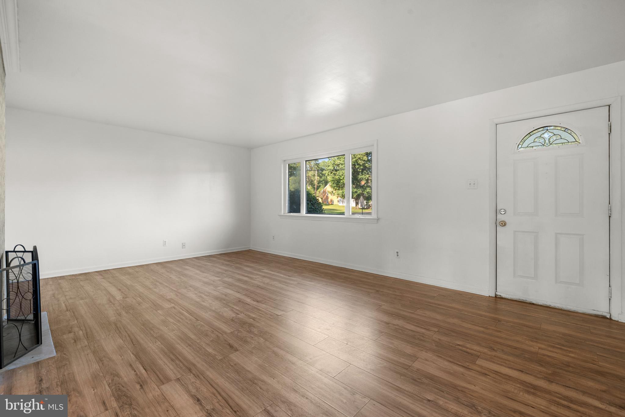 5505 Heming Avenue Springfield, VA 22151 - Photo 6 of 37 a view of an empty room with wooden floor and a window