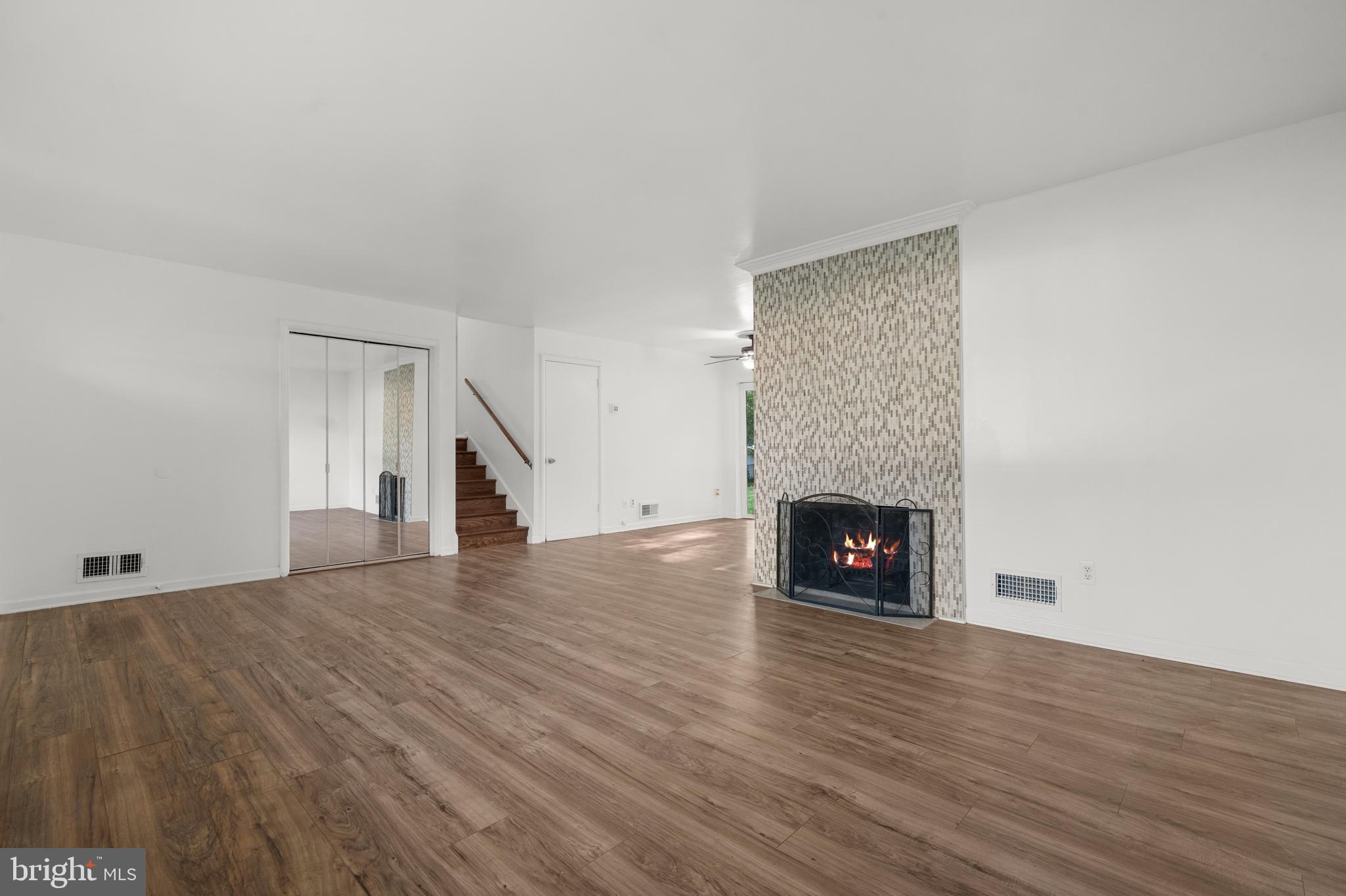 5505 Heming Avenue Springfield, VA 22151 - Photo 7 of 37 a view of an empty room with wooden floor fireplace and a window