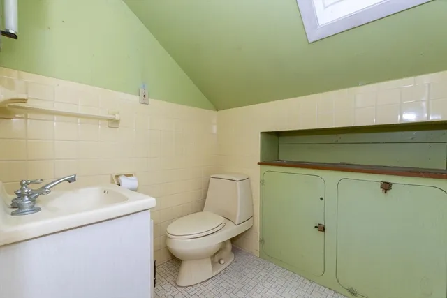 a bathroom with a toilet sink and vanity
