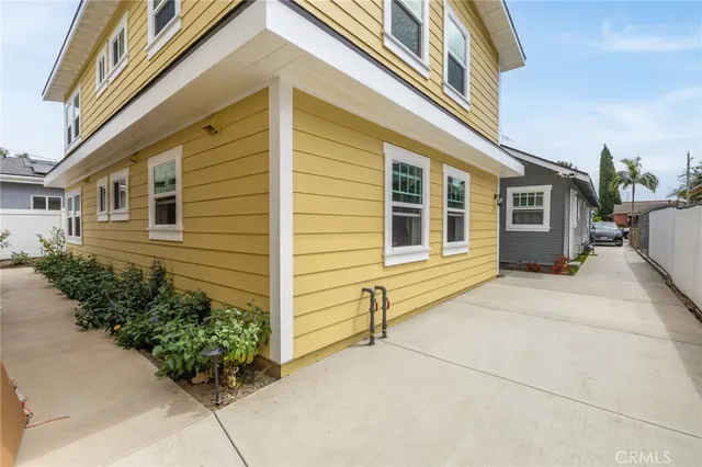 a view of a house with potted plants