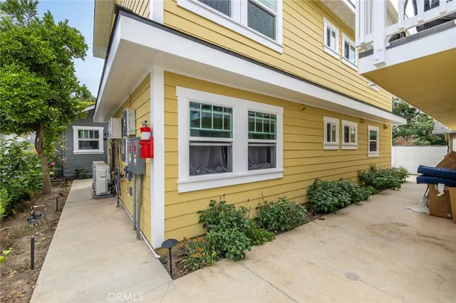 a view of a house with potted plants