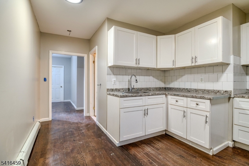 412 South 7th Street, Unit 1 Newark, NJ 07103 - Photo 3 of 11 a kitchen with granite countertop white cabinets and white appliances