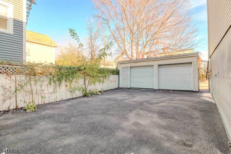 412 South 7th Street, Unit 1 Newark, NJ 07103 - Photo 9 of 11 a view of large house with a yard and garage