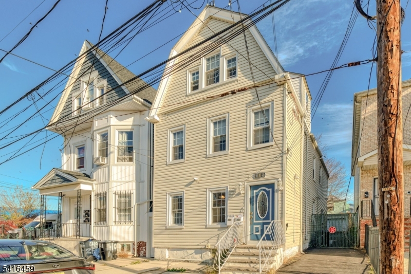 412 South 7th Street, Unit 1 Newark, NJ 07103 - Photo 10 of 11 a front view of a residential apartment building with a yard
