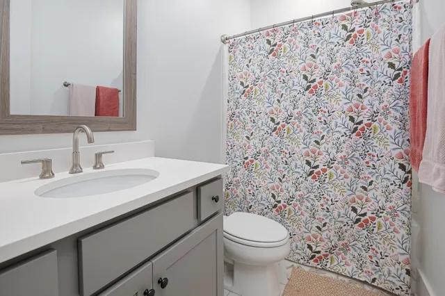a bedroom with a bed table and window