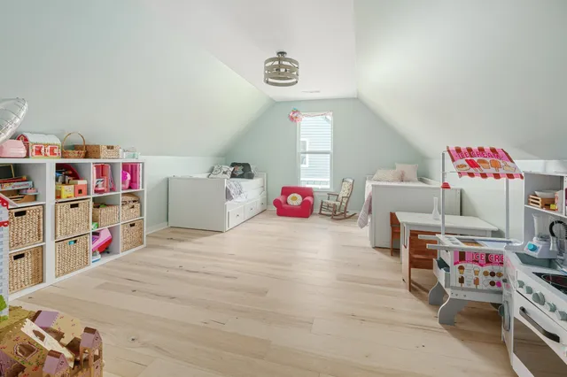 a bedroom with furniture and a wooden floor