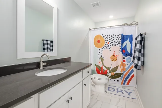 a living room with furniture a couch and dresser