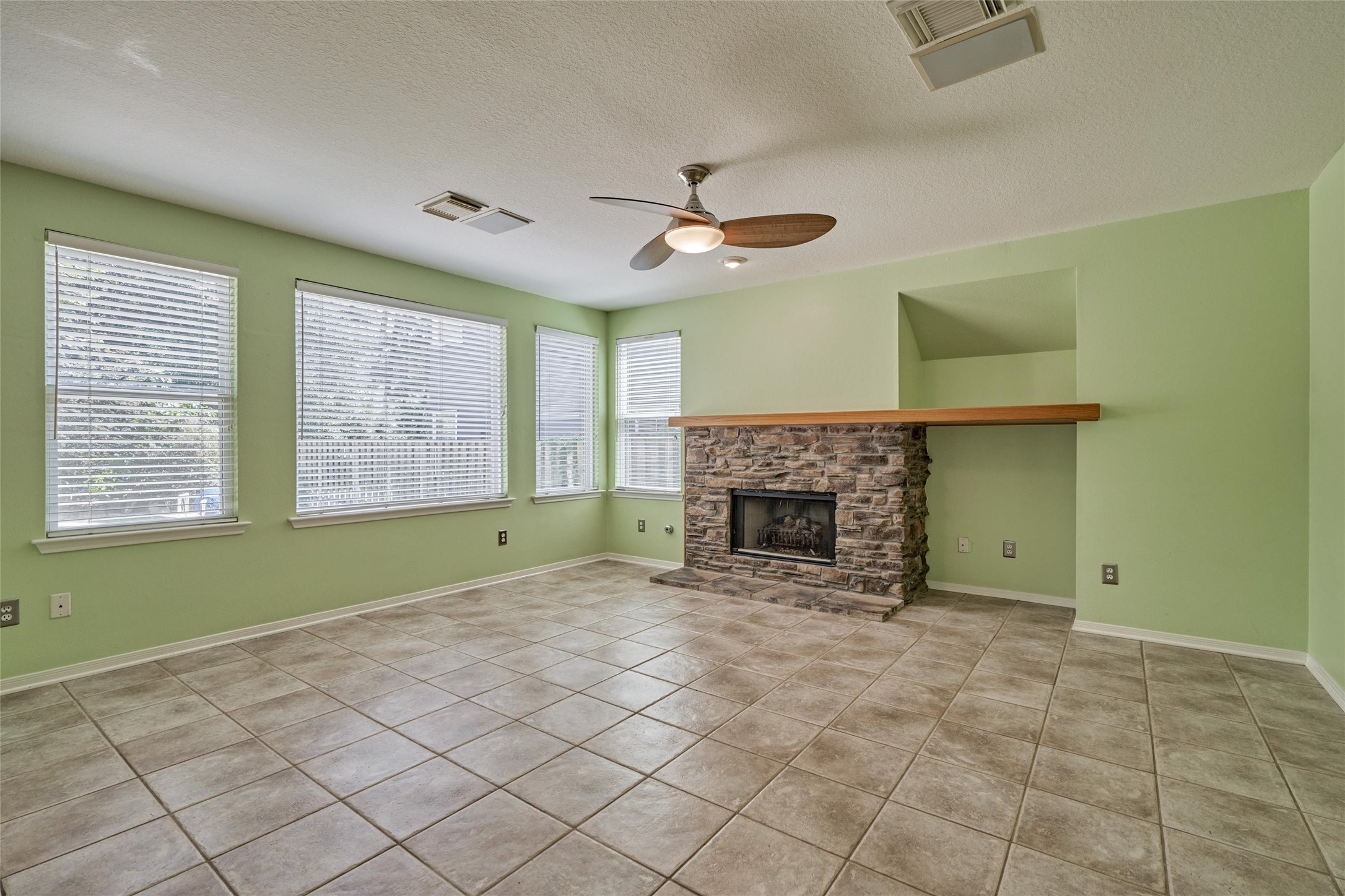59 West Gaslight Place Spring, TX 77382 - Photo 15 of 47 Family room with fireplace and windows to backyard and pool. Interior paint is now white.