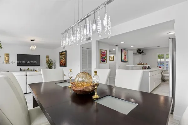 a view of dining room and kitchen with a table chairs and wooden floor