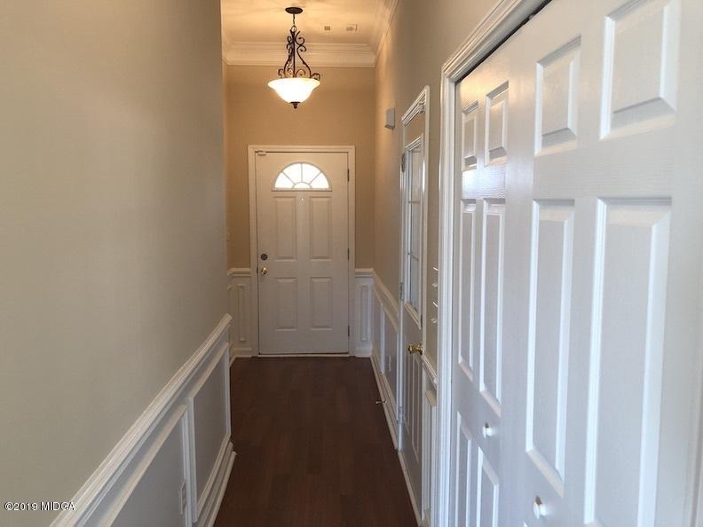 443 Bob White Road Macon, GA 31216 - Photo 4 of 7 a view of a hallway with wooden floor and staircase