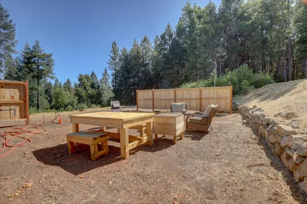a view of a house with backyard and a patio