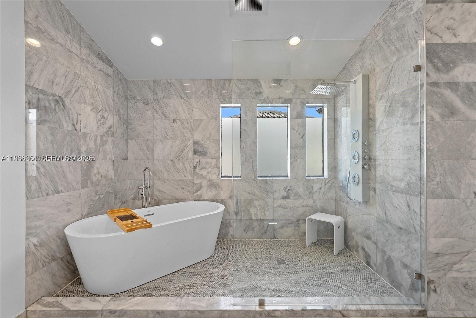22818 El Dorado Drive Boca Raton, FL 33433 - Photo 25 of 37 a bathroom with a bathtub and shower