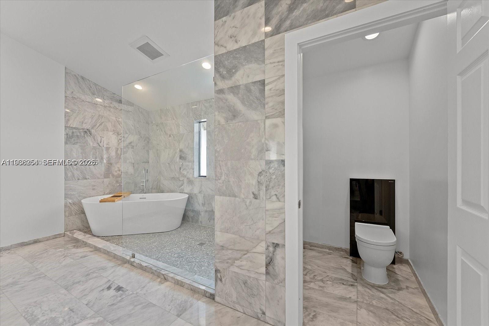 22818 El Dorado Drive Boca Raton, FL 33433 - Photo 26 of 37 a bathroom with a bathtub and toilet