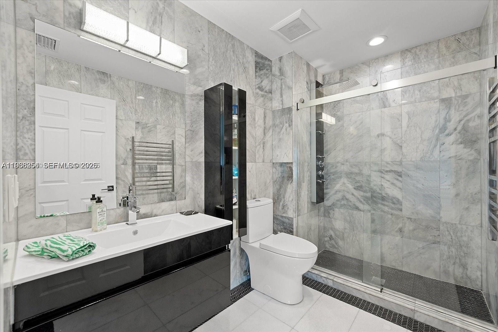 22818 El Dorado Drive Boca Raton, FL 33433 - Photo 33 of 37 a bathroom with a double vanity sink toilet and shower