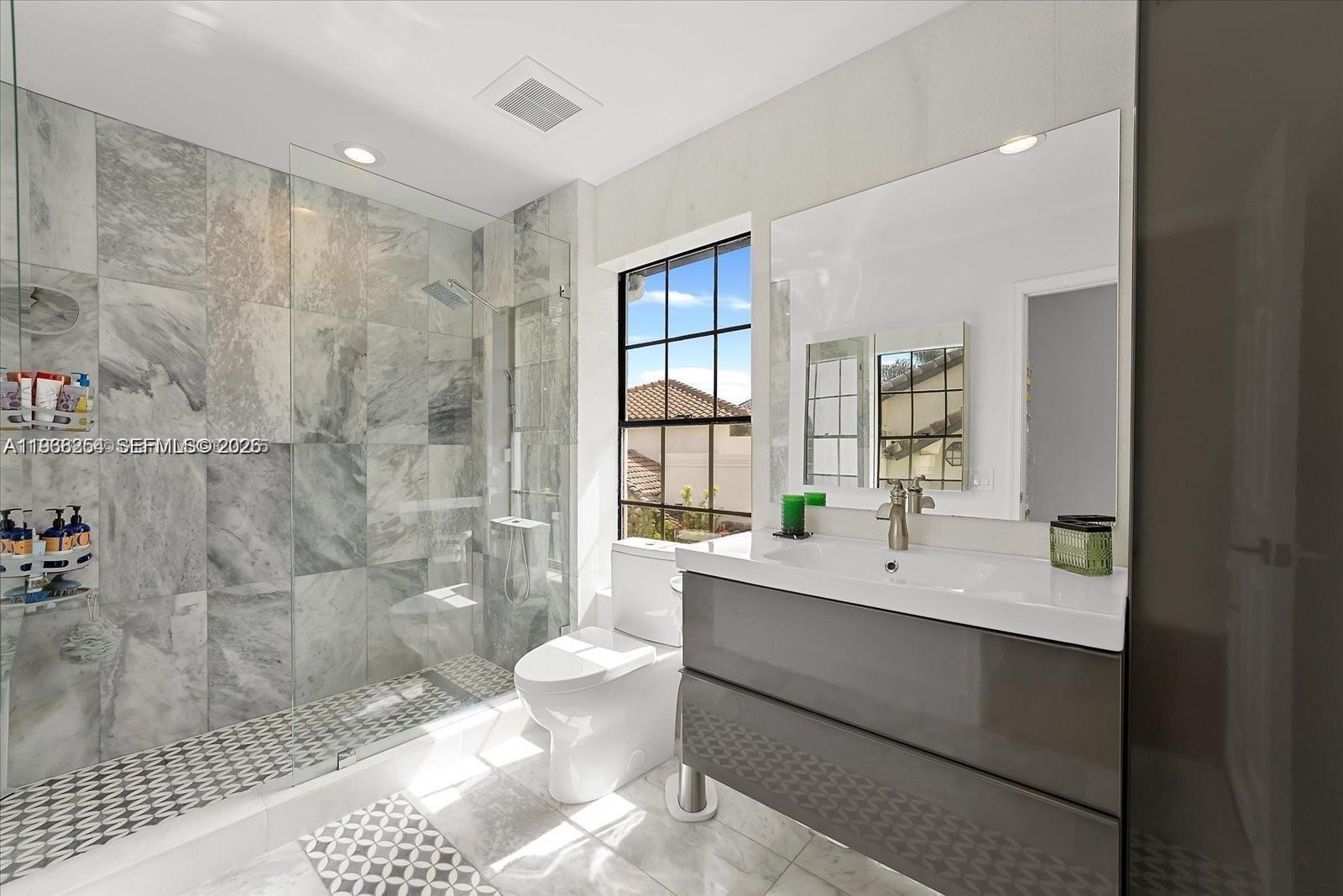 22818 El Dorado Drive Boca Raton, FL 33433 - Photo 34 of 37 a bathroom with a double vanity sink toilet mirror and bathtub