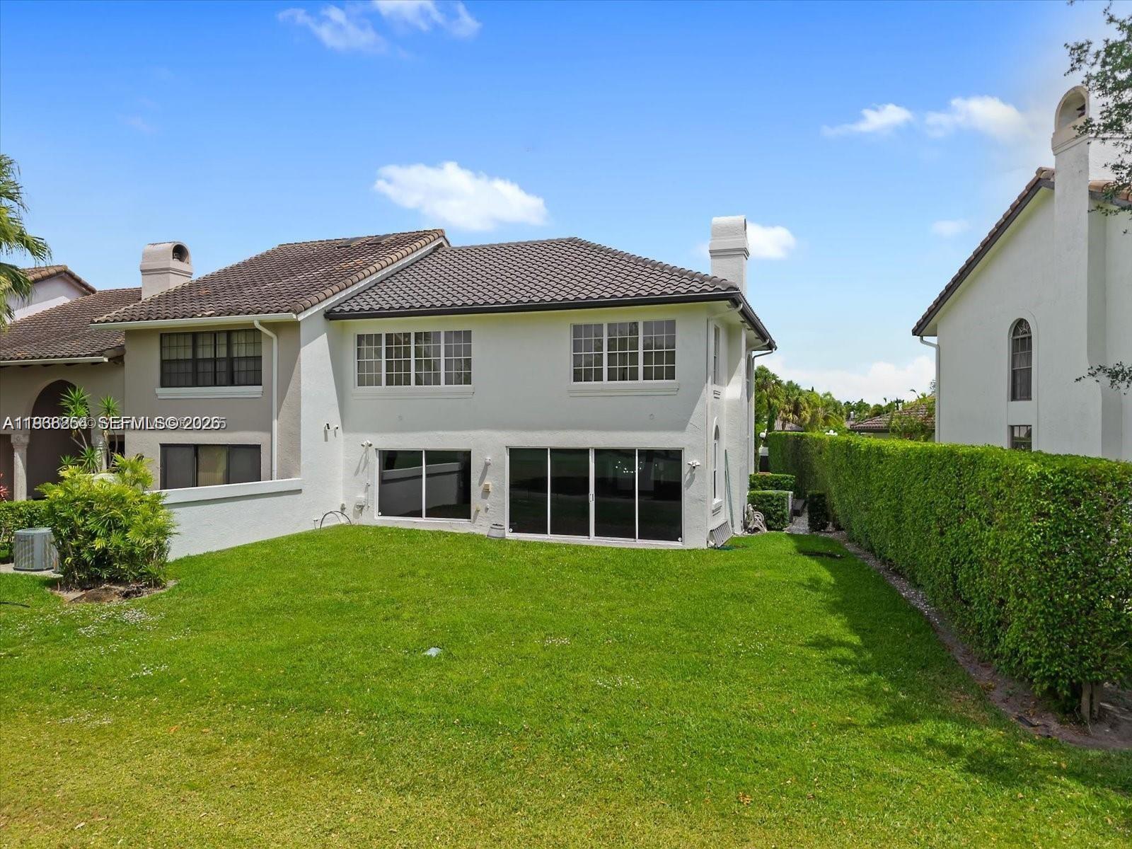 22818 El Dorado Drive Boca Raton, FL 33433 - Photo 4 of 37 a view of a house with a yard