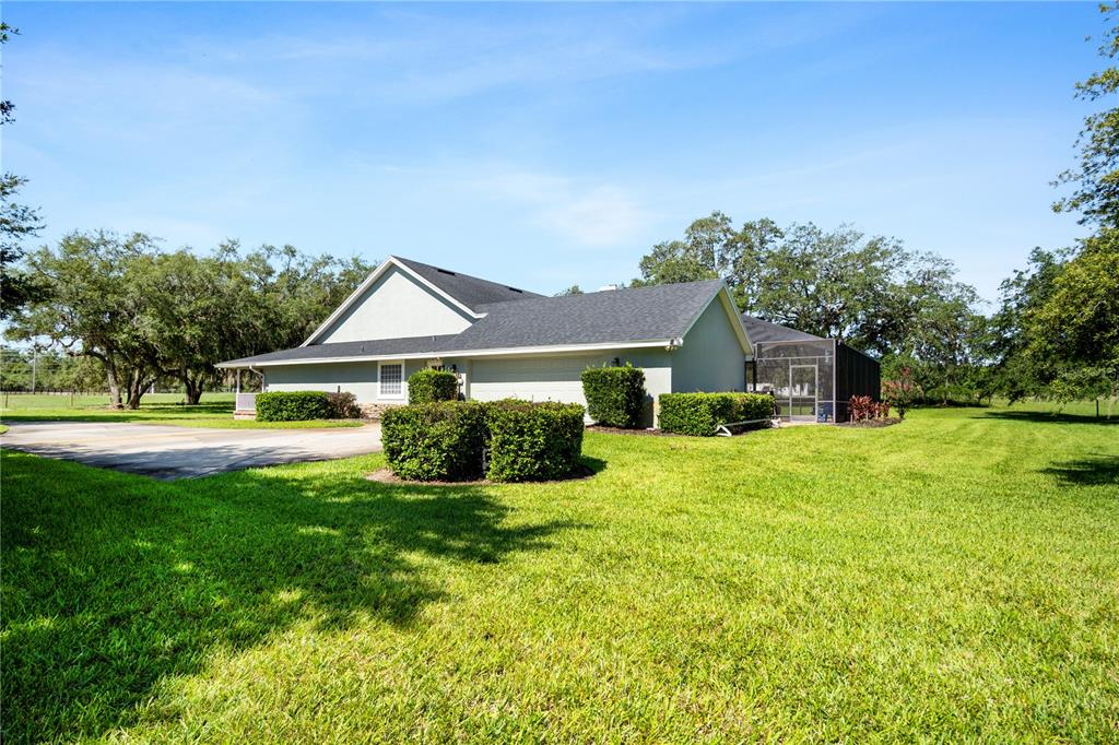 9045 Lake Hatchineha Road Kissimmee, FL 34759 - Photo 6 of 47 a front view of a house with yard and green space