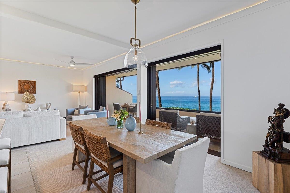 4850 Makena Alanui Road, Unit E205 Kihei, HI 96753 - Photo 11 of 45 a view of a dining room with furniture and a chandelier