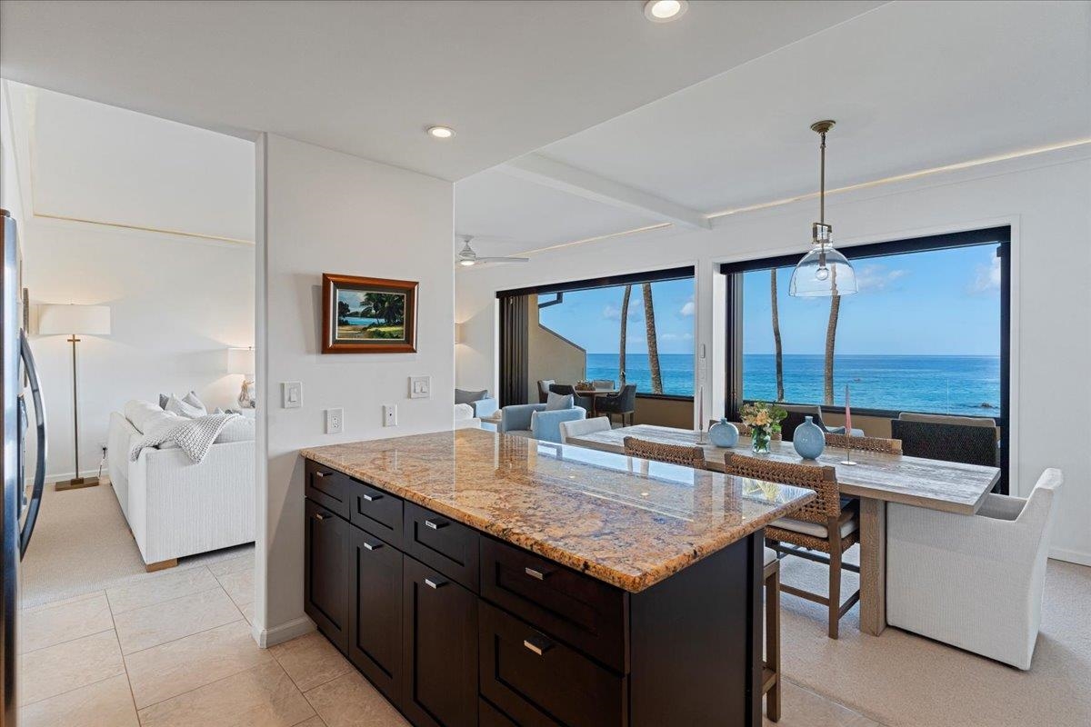 4850 Makena Alanui Road, Unit E205 Kihei, HI 96753 - Photo 13 of 45 a kitchen with stainless steel appliances granite countertop a sink and a refrigerator