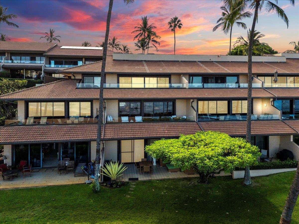 4850 Makena Alanui Road, Unit E205 Kihei, HI 96753 - Photo 16 of 45 a view of a house with a yard and a patio
