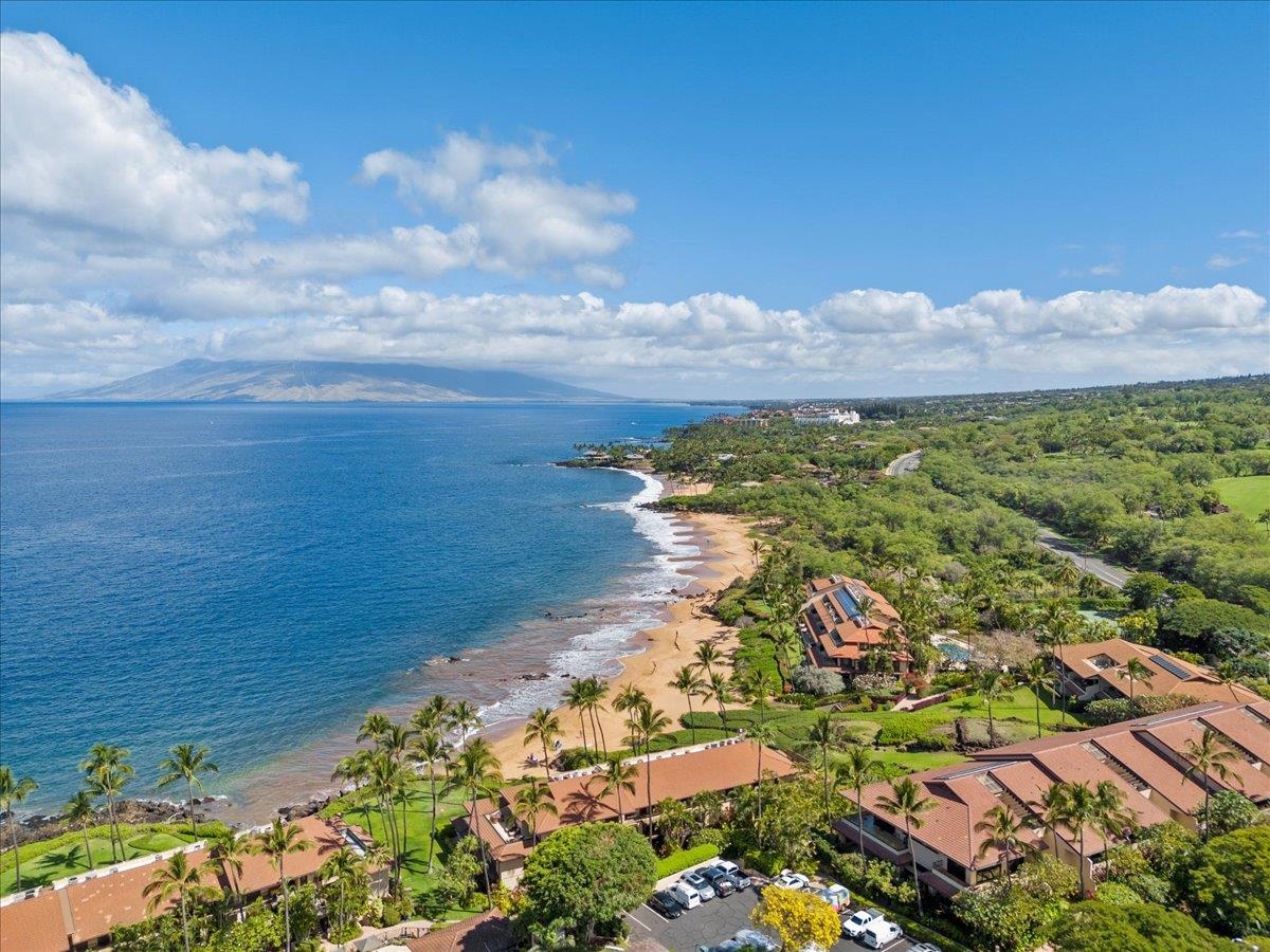 4850 Makena Alanui Road, Unit E205 Kihei, HI 96753 - Photo 17 of 45 a view of a lake with a building in the background