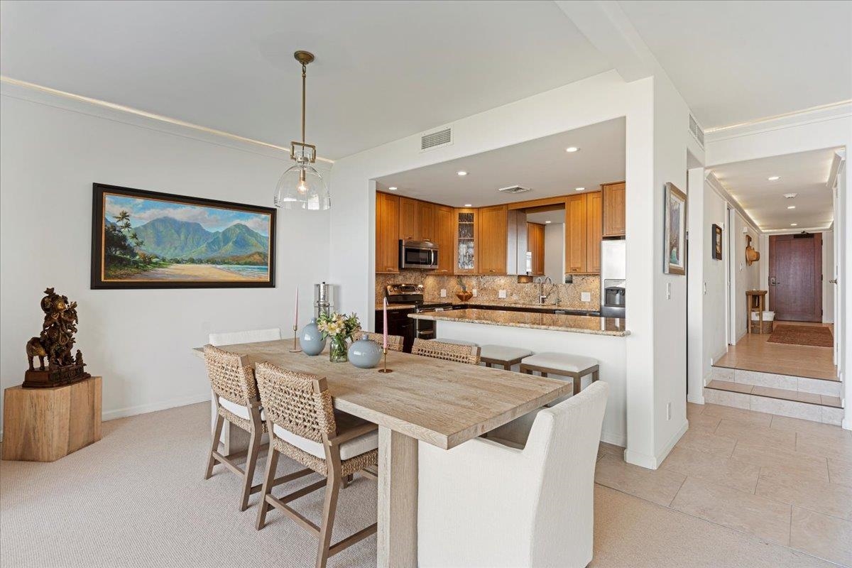 4850 Makena Alanui Road, Unit E205 Kihei, HI 96753 - Photo 9 of 45 a view of a dining room and livingroom with furniture wooden floor a chandelier