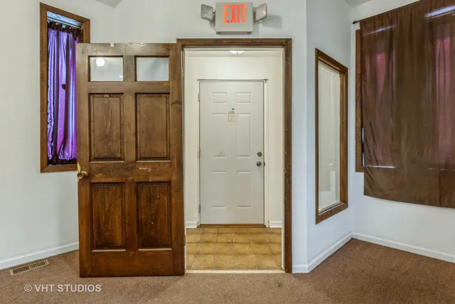 a view of an entryway with wooden floor