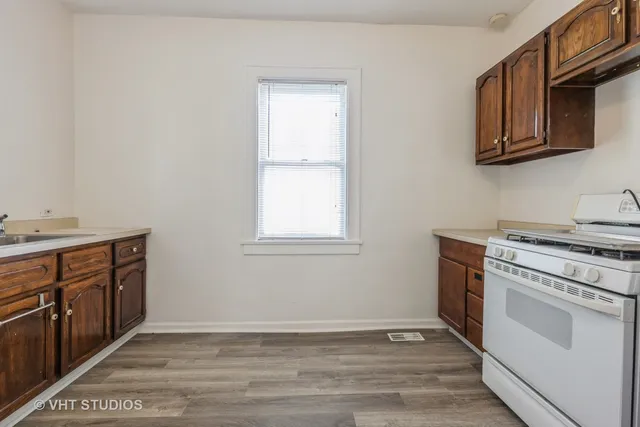 a kitchen with stainless steel appliances granite countertop a stove and a sink