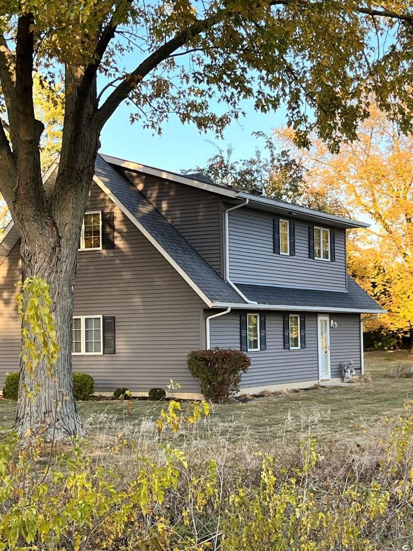 206 South Cherry Street Crescent City, IL 60928 - Photo 2 of 13 a house that has a tree in front of the house