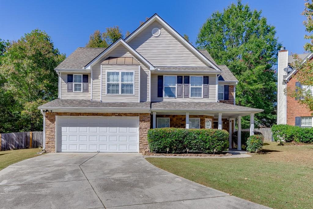3931 Bogan Mill Road Northeast Buford, GA 30519 - Photo 1 of 1 a front view of a house with a yard and garage