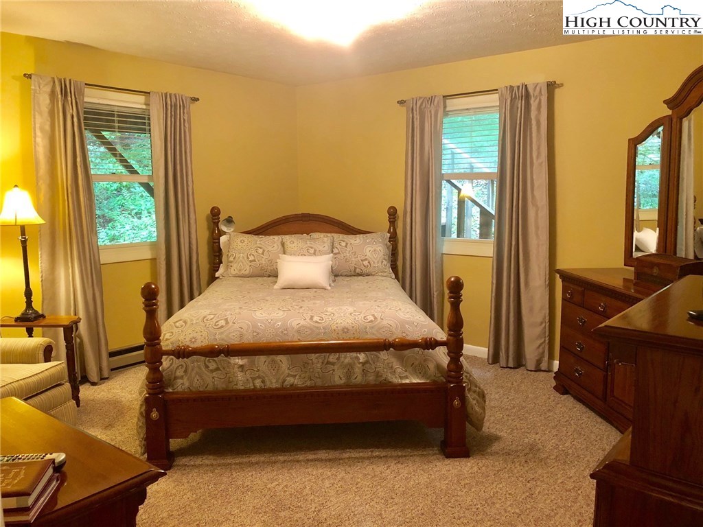 257 Cameron Terrace Boone, NC 28607 - Photo 14 of 42 a bedroom with a bed and wooden floor