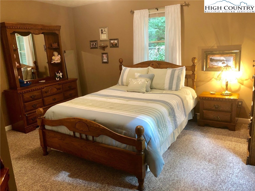 257 Cameron Terrace Boone, NC 28607 - Photo 18 of 42 a bedroom with a bed and wooden floor