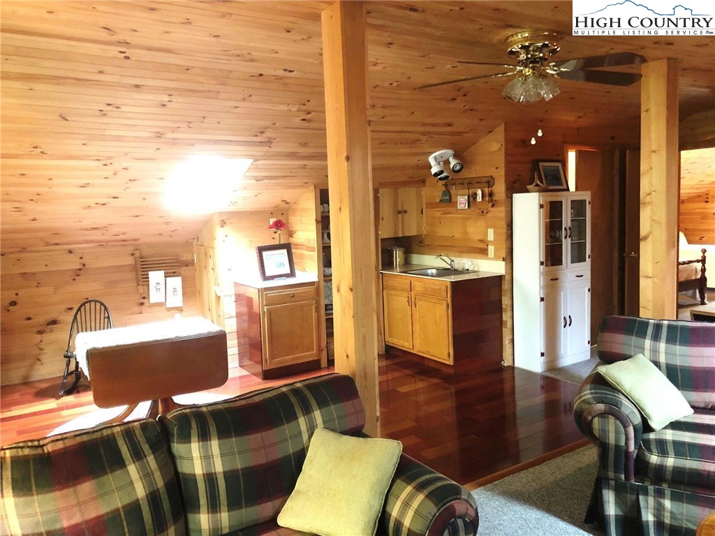 257 Cameron Terrace Boone, NC 28607 - Photo 25 of 42 a living room with furniture a dining table and chairs with wooden floor