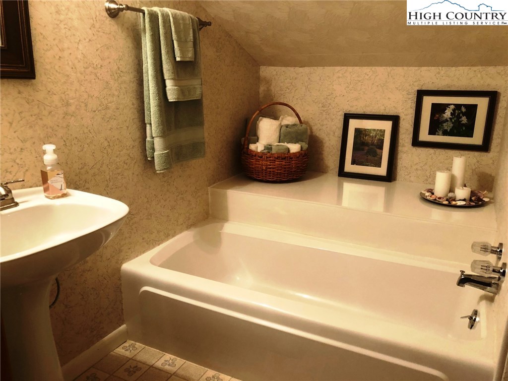 257 Cameron Terrace Boone, NC 28607 - Photo 27 of 42 a bathroom with a tub sink and mirror