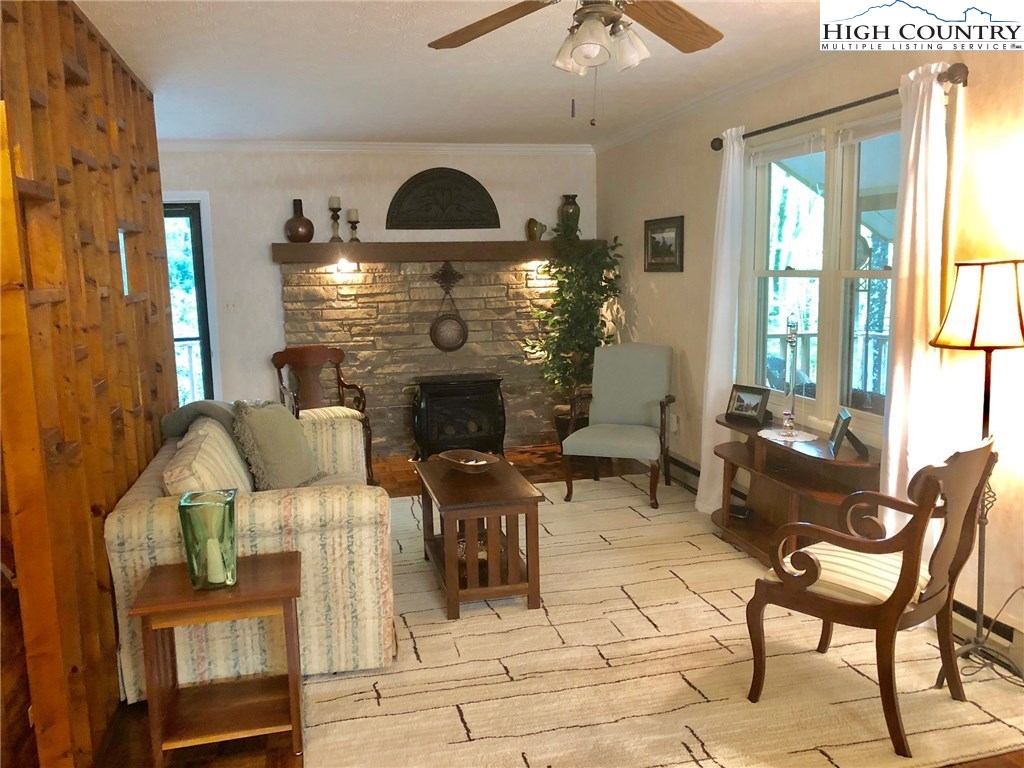 257 Cameron Terrace Boone, NC 28607 - Photo 6 of 42 a living room with furniture a chandelier and a fireplace