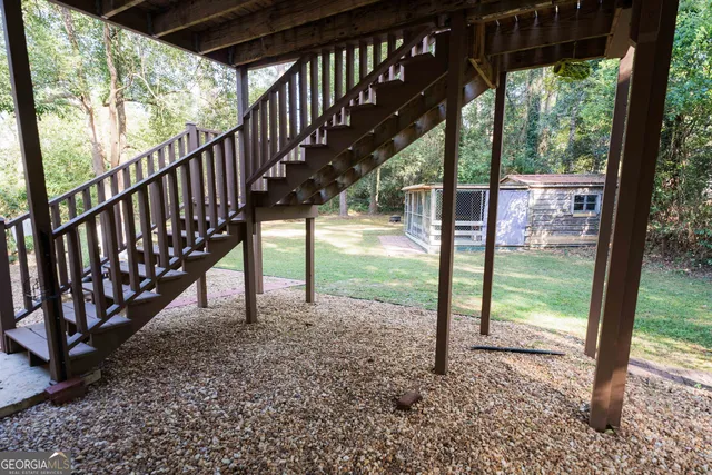 a view of a chairs and table in the roof deck