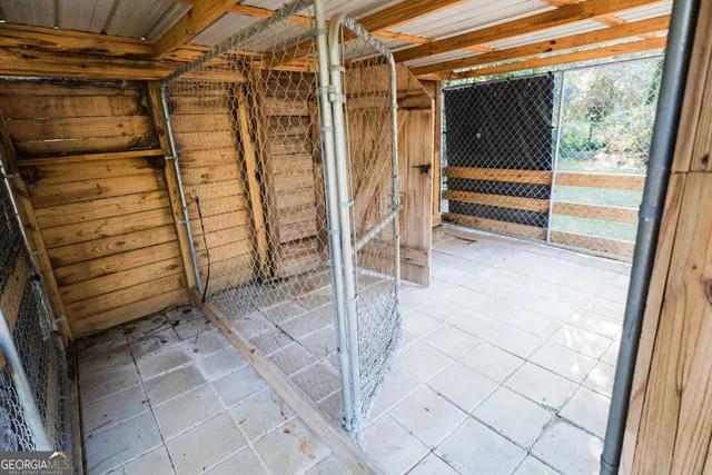 a front view of a house with a garden and trees