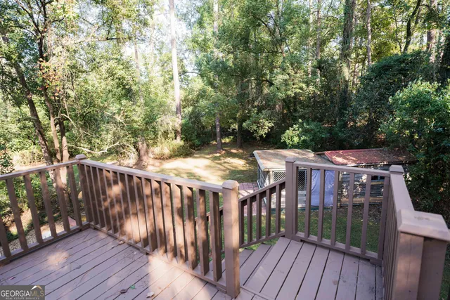 a view of a dining room with furniture a chandelier and wooden floor