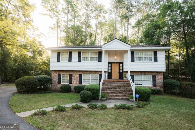 a bedroom with bed and a chandelier