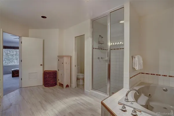 a bathroom with a tub and shower