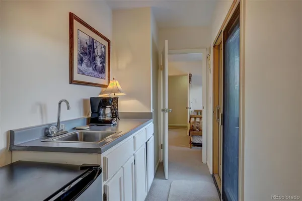a kitchen with a sink and a refrigerator