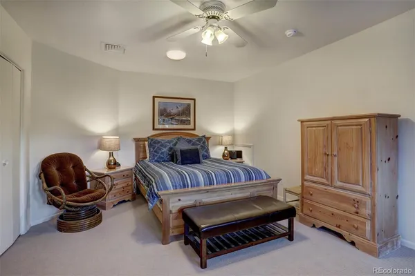 a bedroom with bed and a chandelier