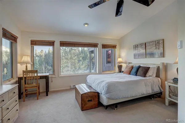 a living room with a bed furniture and a large window