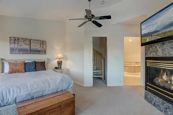 a bedroom with a bed and a fireplace