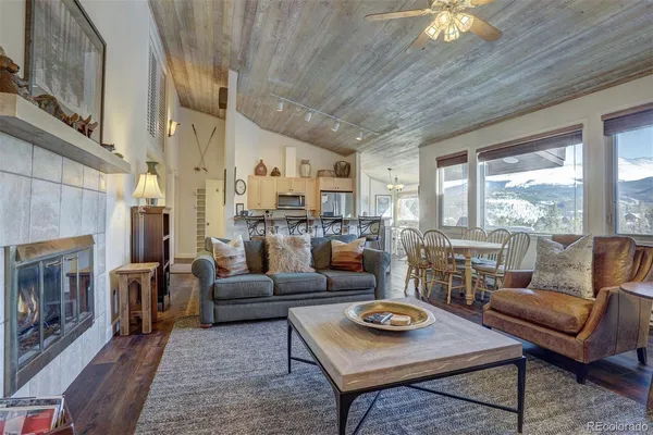 a living room with furniture a fireplace and a table
