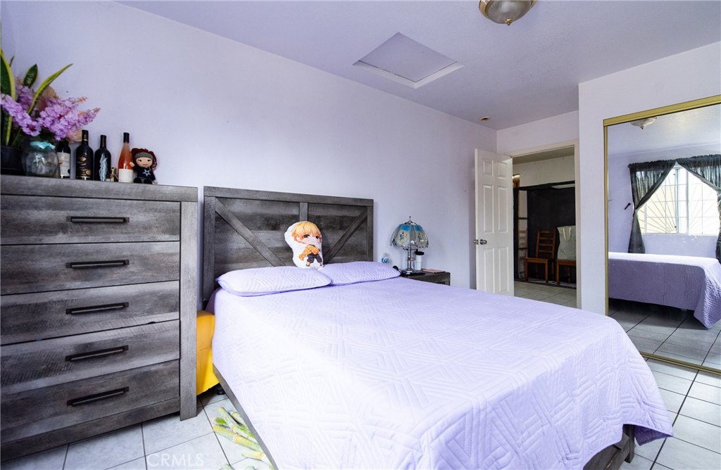14527 Corlett Avenue Compton, CA 90220 - Photo 22 of 30 a bedroom with a bed and a potted plant