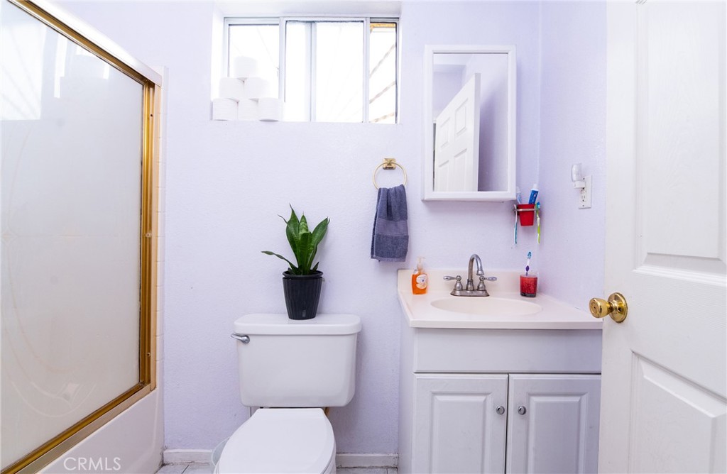 14527 Corlett Avenue Compton, CA 90220 - Photo 23 of 30 a bathroom with a sink a toilet and a mirror