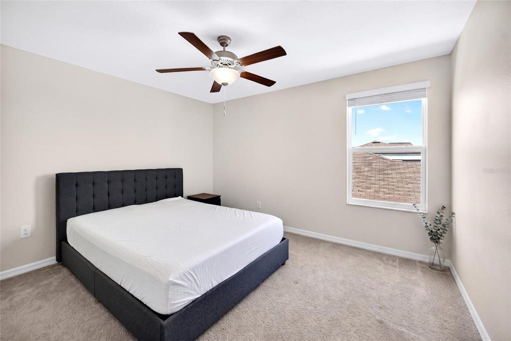 31724 Sun Kettle Loop Wesley Chapel, FL 33545 - Photo 32 of 49 a white bed sitting in a bedroom next to a window
