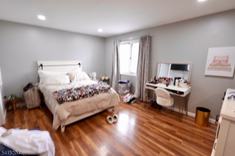 4 Sickle Street Dover, NJ 07801 - Photo 17 of 45 a bedroom with a bed and a couch