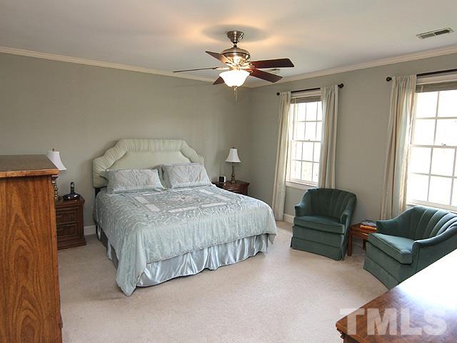 8013 Shellnut Road Raleigh, NC 27615 - Photo 13 of 25 a spacious bedroom with a bed and furniture